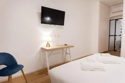 a room with a bed and a table and a chair at Residenza Lungotevere dei Mellini in Rome