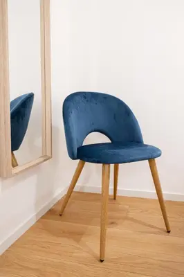 a blue chair in front of a mirror at Residenza Lungotevere dei Mellini in Rome