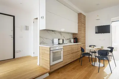 a kitchen and dining room with a table and chairs at Residenza Lungotevere dei Mellini in Rome