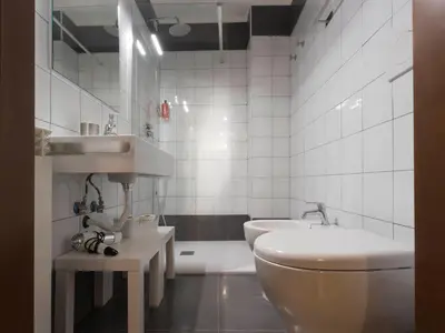 a bathroom with a toilet and a sink and a tub at Domus 1886 (Quartiere Prati) in Rome