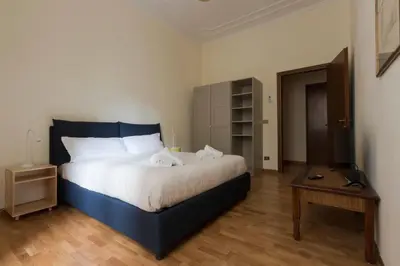 a bedroom with a large bed and a television at Domus 1886 (Quartiere Prati) in Rome