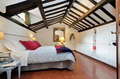 a bedroom with a large bed with red pillows at Benedetta21 in Rome