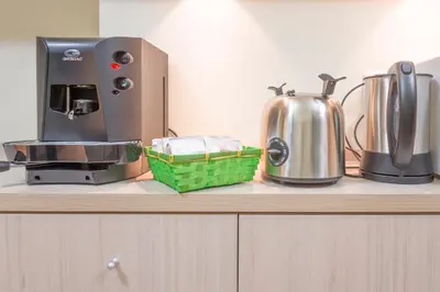 a counter top with a coffee maker and a toaster at Trastevere Chic in Rome
