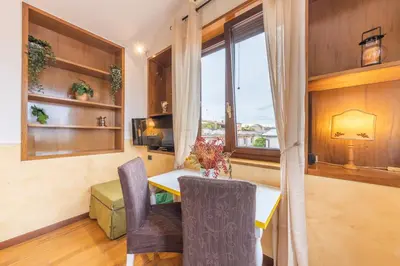 a dining room with a table and a window at AC21 - Panoramic Studio in Rome