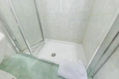 a shower with a white tub in a bathroom at AC21 - Panoramic Studio in Rome