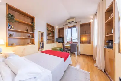 a bedroom with a bed and a desk and a television at AC21 - Panoramic Studio in Rome
