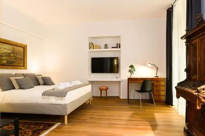 a bedroom with a bed and a tv on a wall at Central near Vatican by NDP rent in Rome