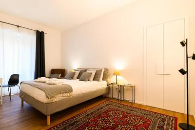 a bedroom with a large bed with a red rug at Central near Vatican by NDP rent in Rome