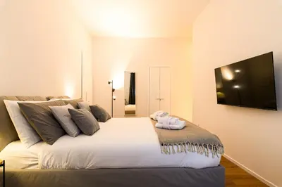 a bedroom with a white bed with a blanket on it at Central near Vatican by NDP rent in Rome