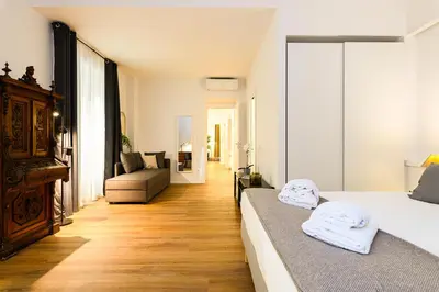 a bedroom with a bed and a living room at Central near Vatican by NDP rent in Rome