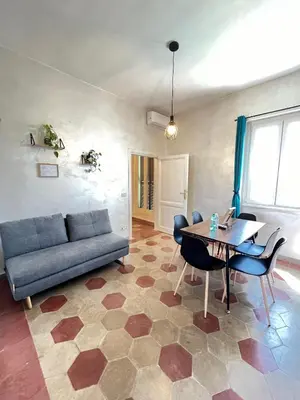 a living room with a couch and a table at Il Nido apartment Roma, Attico ostiense in Rome