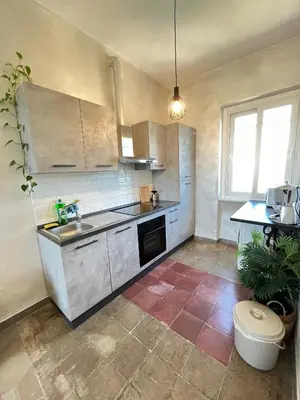 a kitchen with a sink and a counter top at Il Nido apartment Roma, Attico ostiense in Rome