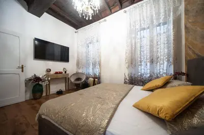 a bedroom with a large bed and a television at Pantheon Charming Accommodation in Rome