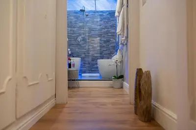 a hallway with a bathroom with a tub in a window at Pantheon Charming Accommodation in Rome