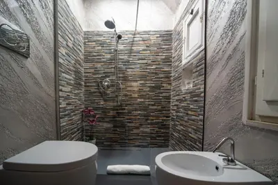 a bathroom with a shower and a toilet and a sink at Pantheon Charming Accommodation in Rome