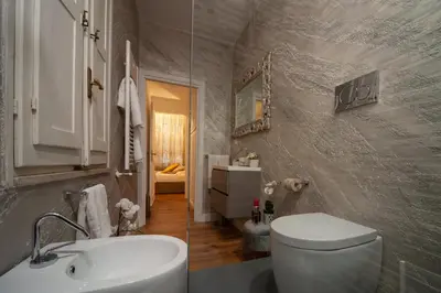 a bathroom with a white toilet and a sink at Pantheon Charming Accommodation in Rome
