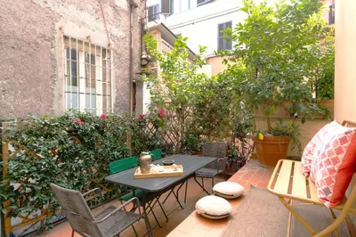 a living room with a table and a dining room at Trevi My Charming Holiday Home, at Trevi Fountain in Rome