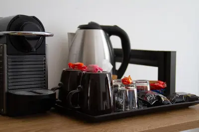 a tray with cups and a coffee pot on a table at Michelangelo Vatican Rooms in Rome
