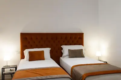 two beds sitting next to each other in a room at Michelangelo Vatican Rooms in Rome