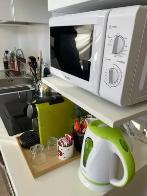 a microwave sitting on a shelf in a kitchen at Betterplace in Rome