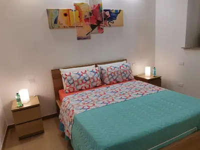a bedroom with a bed and a painting on the wall at Betterplace in Rome