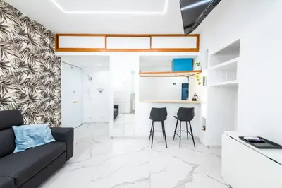a living room with a couch and two chairs at Casa Cate in Rome