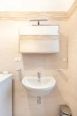 a bathroom with a sink and a mirror at Hostly - Michelangelo Suite Midtown-Center of Rome in Rome