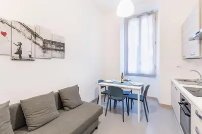 a living room with a couch and a table at Hostly - Michelangelo Suite Midtown-Center of Rome in Rome