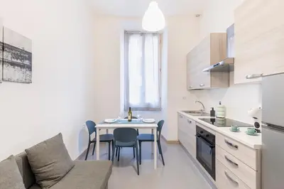 a kitchen and dining room with a table and chairs at Hostly - Michelangelo Suite Midtown-Center of Rome in Rome