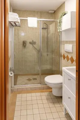 a bathroom with a shower and a toilet and a sink at èROMA - COLOSSEO Apartment in Rome