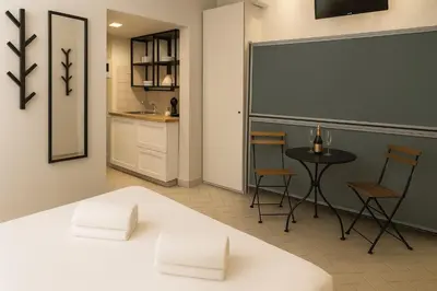 a room with a chalkboard and a table and chairs at èROMA - COLOSSEO Apartment in Rome