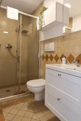a bathroom with a toilet and a shower and a sink at èROMA - COLOSSEO Apartment in Rome