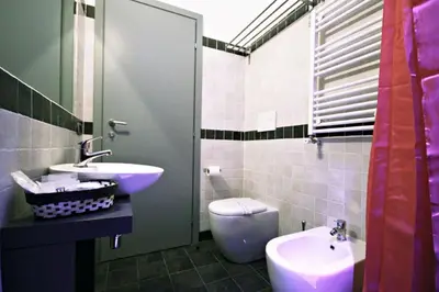 a bathroom with a sink and a toilet and a sink at Affittacamere Tiburstation 2 in Rome