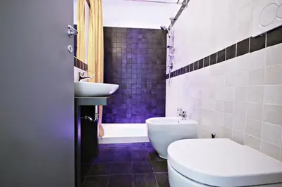 a bathroom with a sink and a toilet and a tub at Affittacamere Tiburstation 2 in Rome