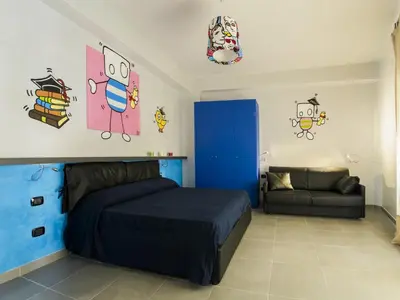 a bedroom with a blue bed and a couch at Affittacamere Tiburstation 2 in Rome