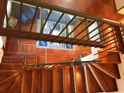 a staircase with wooden floors and a metal railing at Villa Borghese Domus in Rome