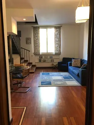 a living room with a blue couch and a table at Villa Borghese Domus in Rome