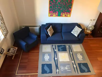 a blue couch and a chair in a living room at Villa Borghese Domus in Rome