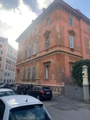 a red brick building with cars parked in front of it at Villa Borghese Domus in Rome