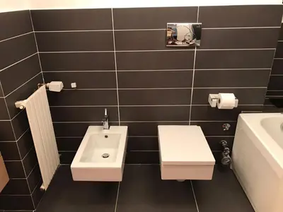 a bathroom with a sink and a toilet and a tub at Villa Borghese Domus in Rome