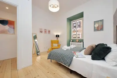 a bedroom with a bed and a chair in it at Gazometro Apartment SelfCheck-in in Rome