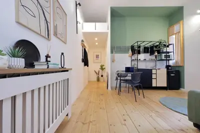 a kitchen and living room with a table and chairs at Gazometro Apartment SelfCheck-in in Rome