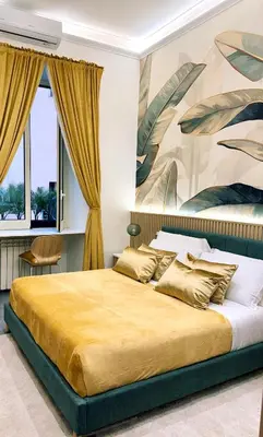 a bedroom with a large bed with a painting on the wall at San Pietro Suite - Vatican City in Rome