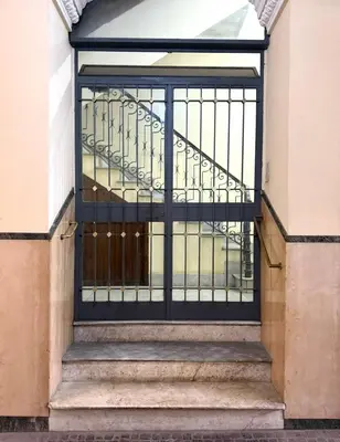 a busy city street with a large building and a street at San Pietro Suite - Vatican City in Rome