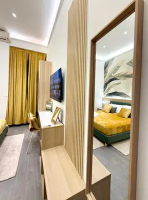 a bedroom with a bed and a table with a lamp at San Pietro Suite - Vatican City in Rome