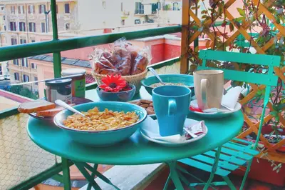 a table with bowls of food on a balcony at Colosseoinn in Rome