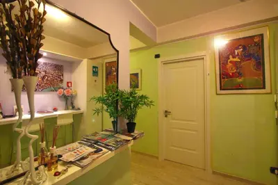 a room with green walls and a mirror and a counter at Colosseoinn in Rome