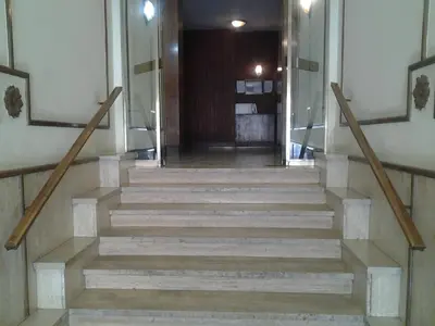 a staircase in a building with a stair case at Colosseoinn in Rome