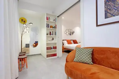 a living room with a couch and a bedroom at YCH-Casa Indipendente in zona Prati in Rome