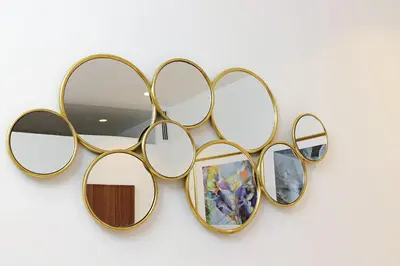 a group of gold sunglasses hanging on a wall at YCH-Casa Indipendente in zona Prati in Rome